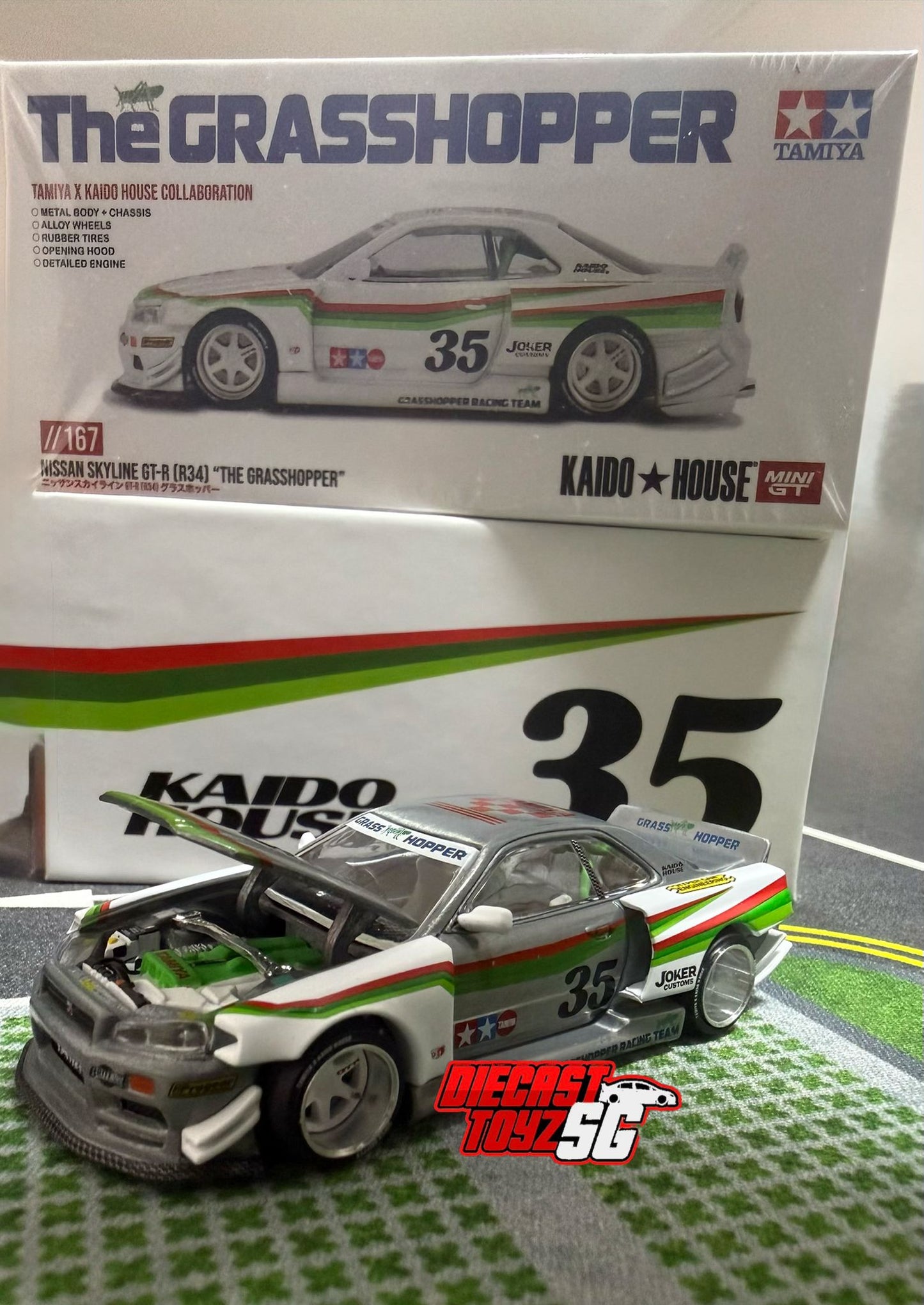 MINI GT X KAIDO HOUSE Nissan Skyline GT-R (R34) TAMIYA x KAIDO HOUSE "The GRASSHOPPER" V1 KHMG167 * CHASE *